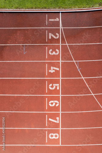 Aerial view of the Manuela Machado Municipal Stadium in Viana do Castelo, Portugal. Eight empty red tracks for running sports with tartan track of synthetic rubber on the athletic stadium.