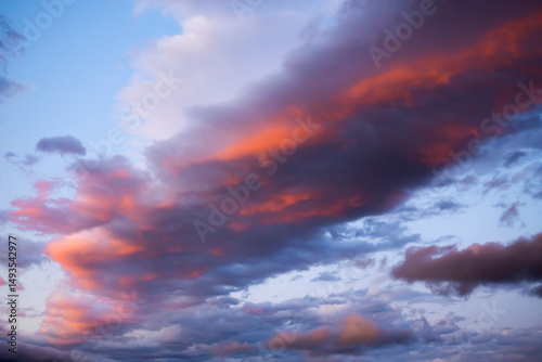 Fiery clouds in the evening blue sky