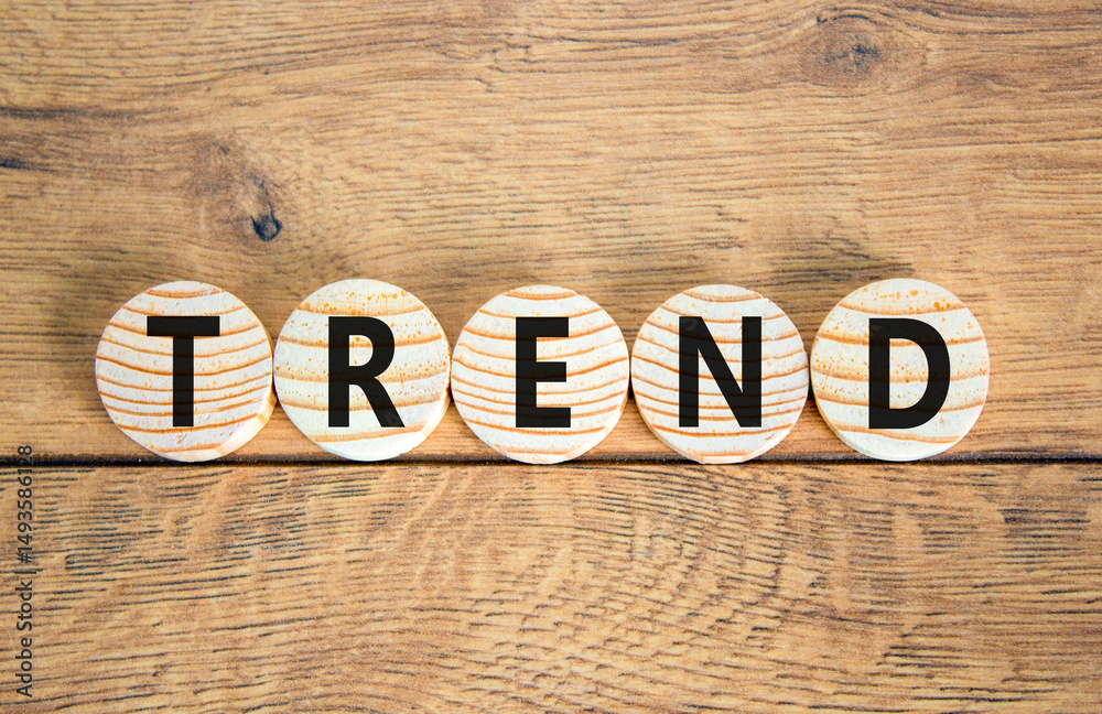 Fototapeta premium Trend and trending symbol. Concept word Trend on beautiful wooden circles. Beautiful wooden table wooden background. Business lifestyle trend and trending concept. Copy space.