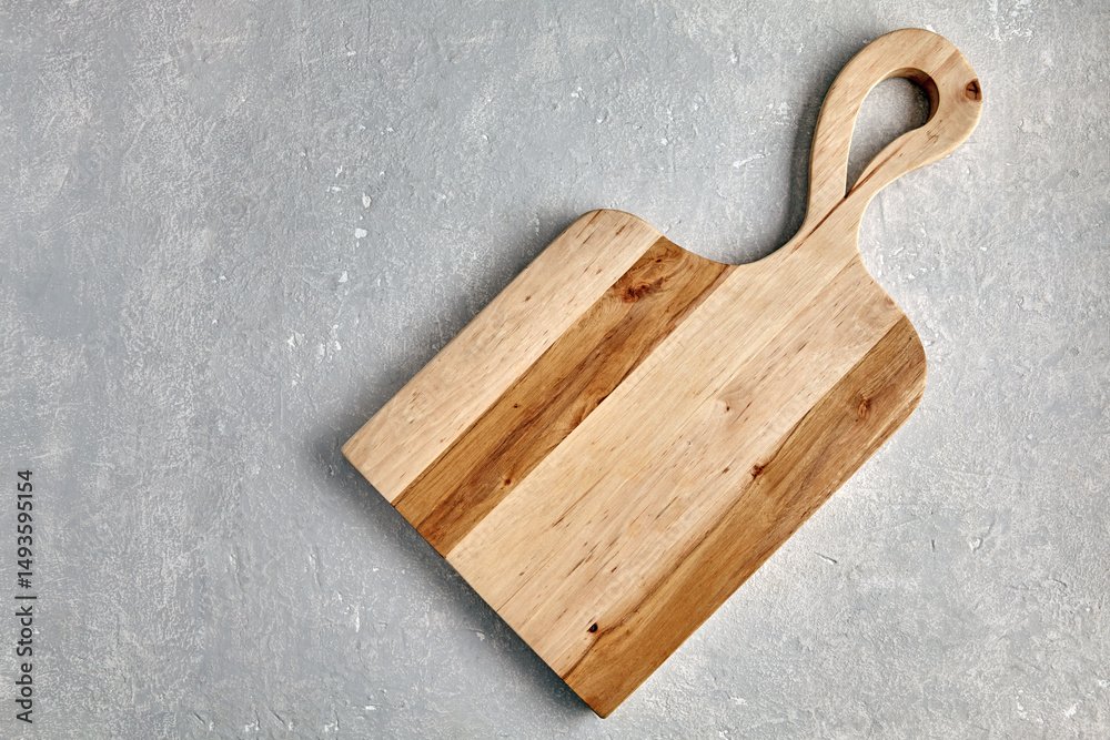 Fototapeta premium figured wooden cutting board on grey stone table