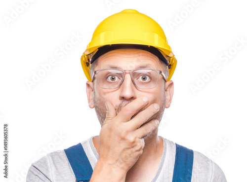 Surprised construction worker stare to camera, isolated on white background. Amazed expression face - head of a amazed repairman. Wao - omg. Craftsman against white wall