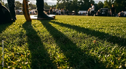 Person Playing Music Outdoors on Grass in Sunlight