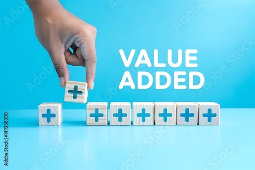 Hand adding plus sign to value added wooden blocks. Business Concept.