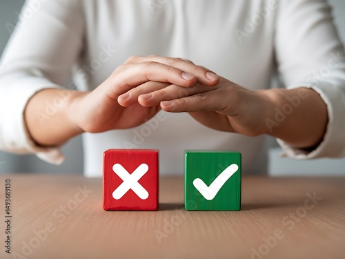 Hands protecting right and wrong choice wooden blocks