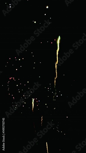 4K. loop seamless of real fireworks background golden shining fireworks with bokeh lights in the night sky. glowing fireworks show. New year's eve fireworks celebration multiple colors in sky