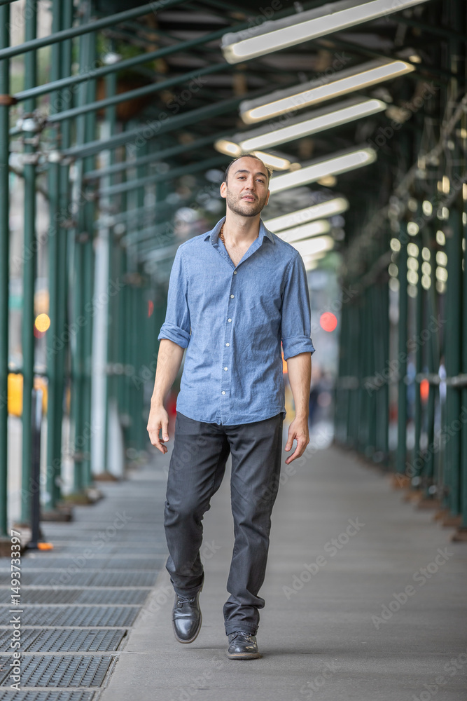 Fototapeta premium Confident Hispanic Man Walking on Urban NY City Manhattan Street in Daylight Setting