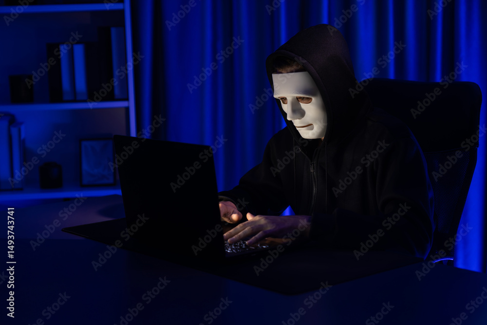 White criminal anonymous mask installing coding password encryption by programming hack, trying to make insecure thorough privacy taking massive database on computer for ransom to company. Pecuniary. White criminal anonymous mask installing coding password encryption by programming hack, trying to make insecure thorough privacy taking massive database on computer for ransom to company. Pecuniary.