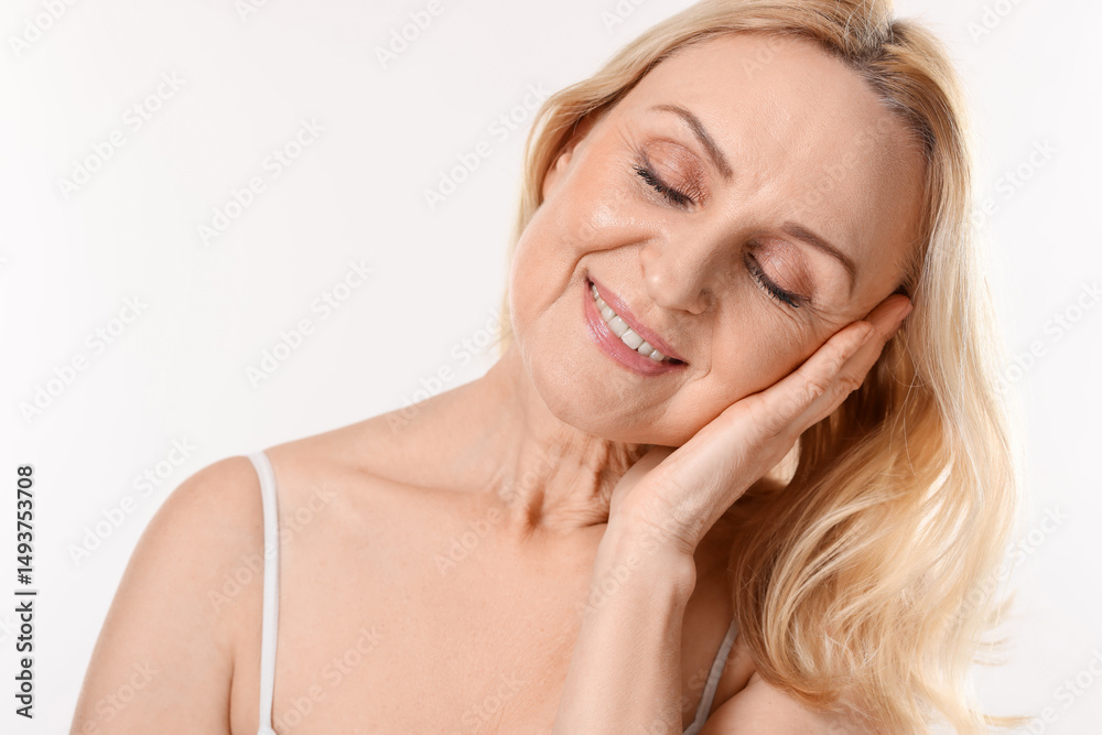 Fototapeta premium Smiling middle aged woman on white background