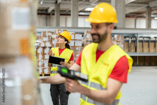 Warehouse workers conduct an inventory check, ensuring accurate tracking and management of products in a busy environment. photo