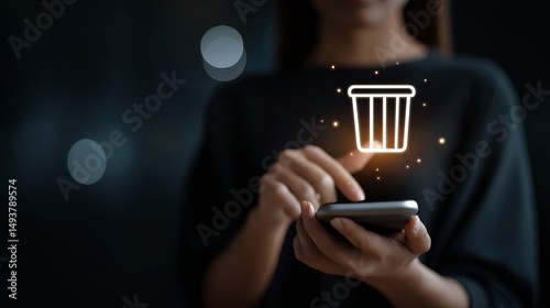 Girl uses smartphone taps trash can icon Concept deleting cleaning files digital order