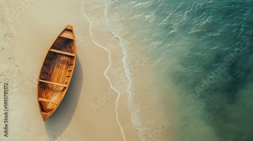 Boat on a sandy beach with gentle waves and clear blue sky during a sunny day
