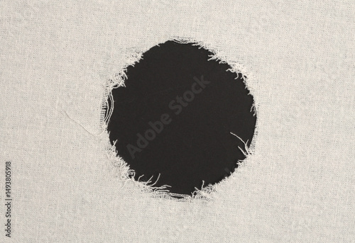 Grunge beige canvas denim fabric torn circle frame. Texture abstract background.