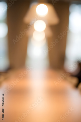 Blurred conference room, featuring lights and a wooden table, ideal for backgrounds