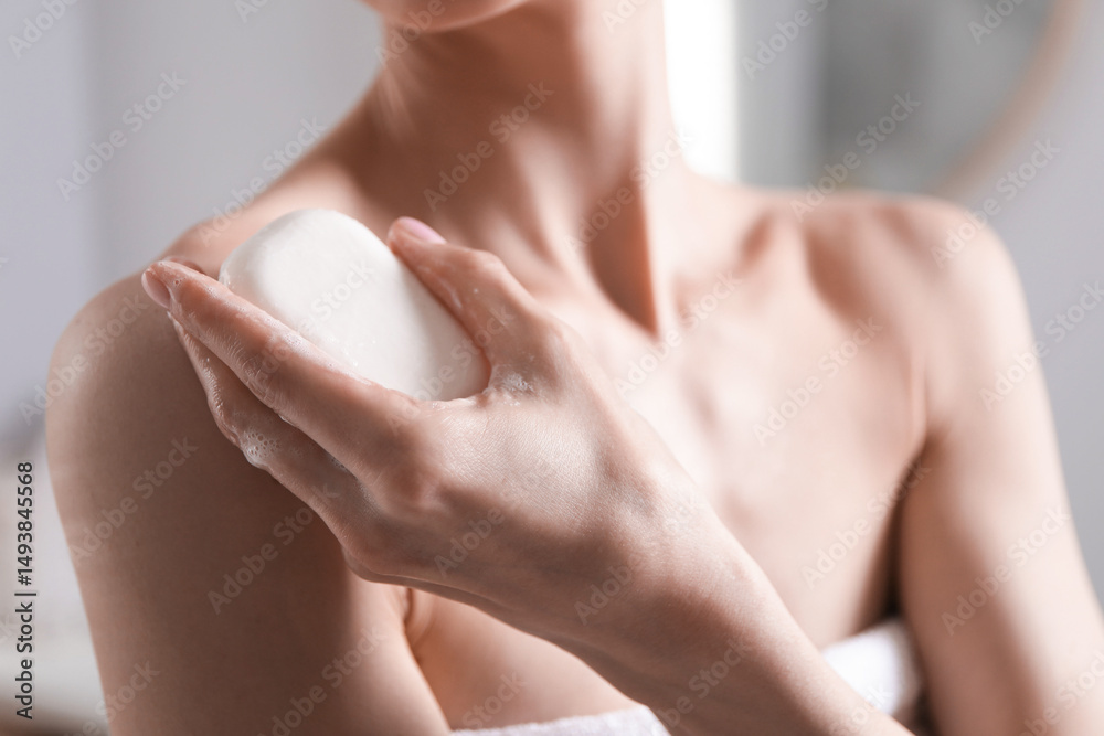 Fototapeta premium Woman with soap bar in bathroom, closeup