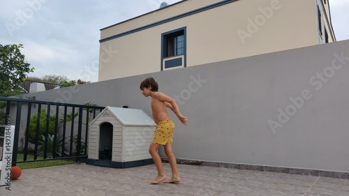 A small white dog house is sitting in front of a large building