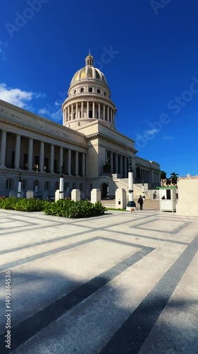 The famous building of the National Capitol in Cuba. HAVANA - DECEMBER 20, 2023: The entrance staircase and the dome of the Capitol in the center of Havana against the background of a blue sunny sky. photo