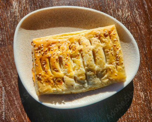 Puff pastry rectangle on a plate, baked food, dish with pastry