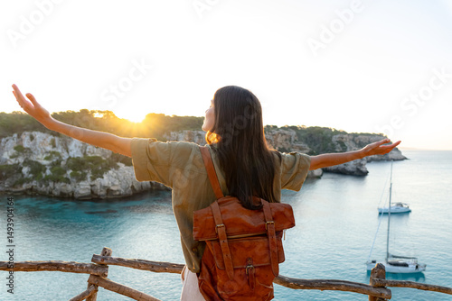 Photos Young female tourist with open arms enjoying freedom and amazing sunrise over be