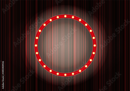 Bright circular marquee sign illuminated against a dark background during a performance setting