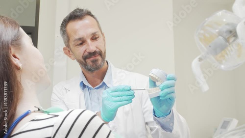 Cheerful male dentist engaging with his female patient