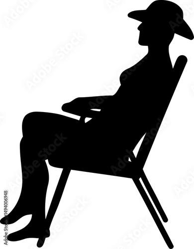 Silhouette of a Woman Wearing a Hat Relaxing in a Beach Chair