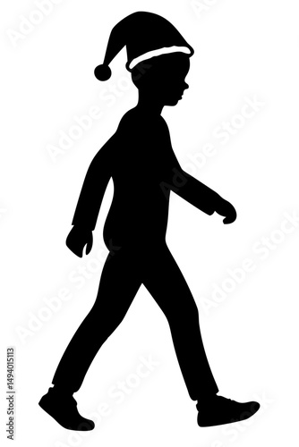 Silhouette of Boy Walking With a Santa Hat During Festive Season at Twilight