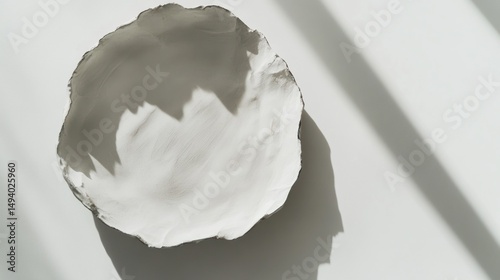 Handcrafted white bowl in sunlight
