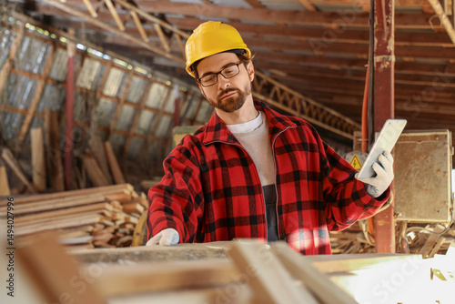 Male carpenter with tablet ...