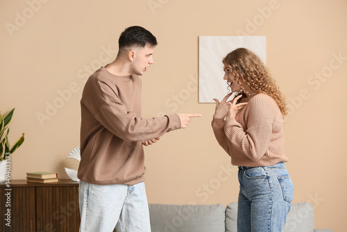 Young couple squabbling in living room