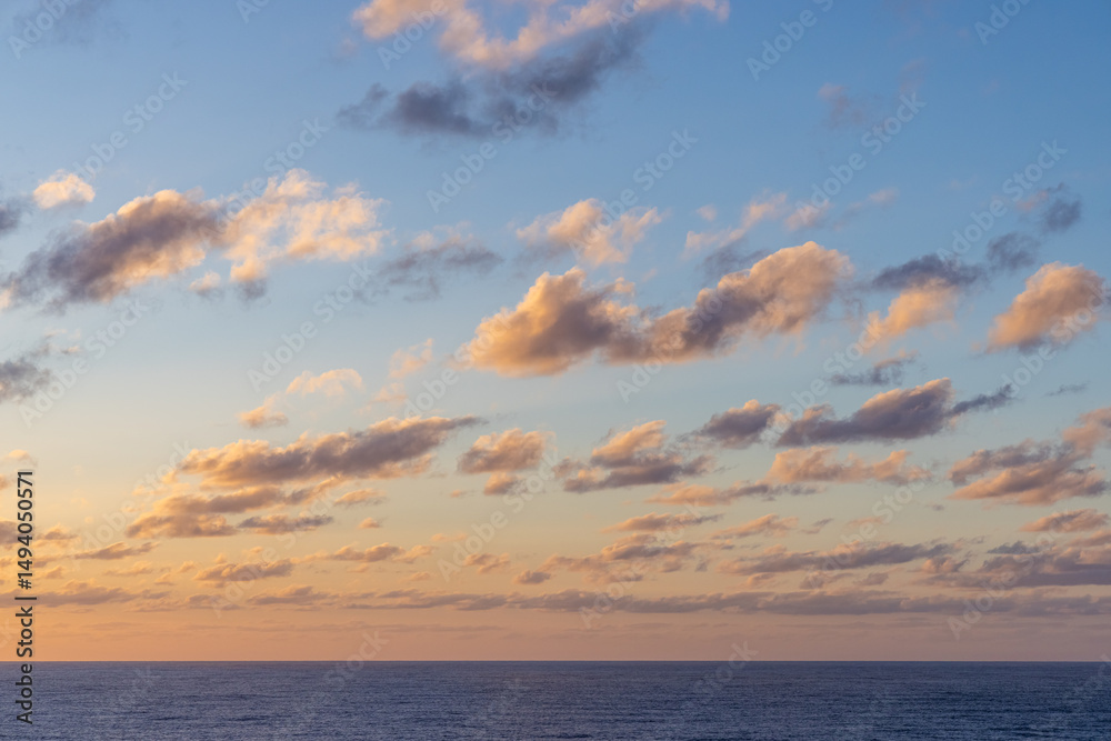 Fototapeta premium Colorful Cloudscape at Sunset Above Calm Pacific Ocean Waters