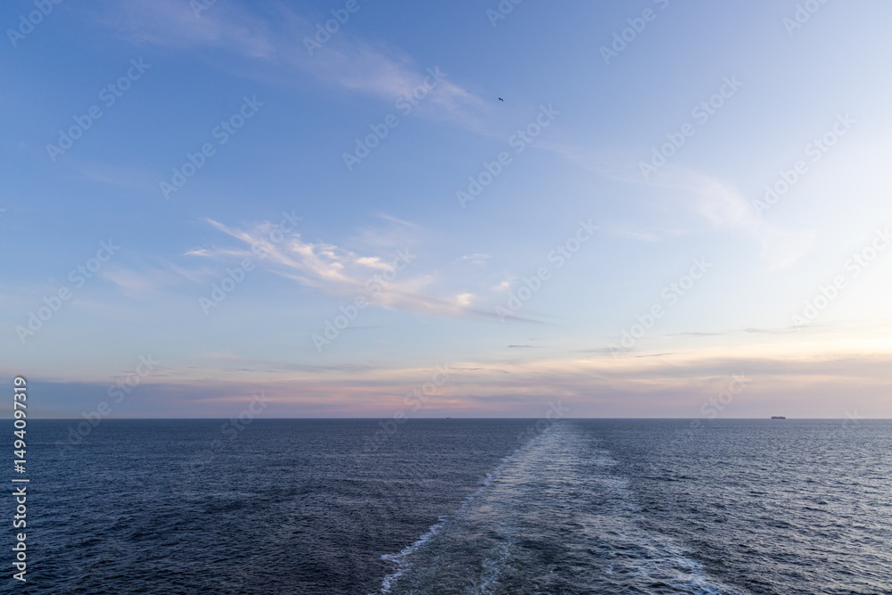 Fototapeta premium Open Ocean Scene During Sunset with Distant Ship on Horizon