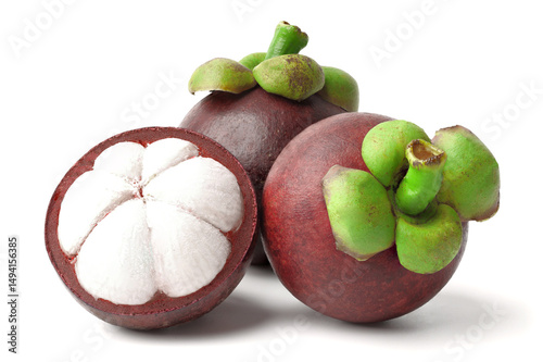 Close-up shot fresh mangosteen cut in half to reveal white flesh and fresh whole mangosteen. isolated on white background.