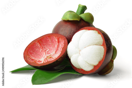 Close-up shot fresh mangosteen cut in half to reveal white flesh and fresh whole mangosteen placed on green leaves. isolated on white background.