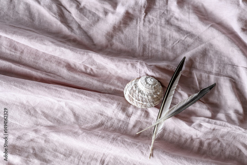 Pink linen material with shell and feather