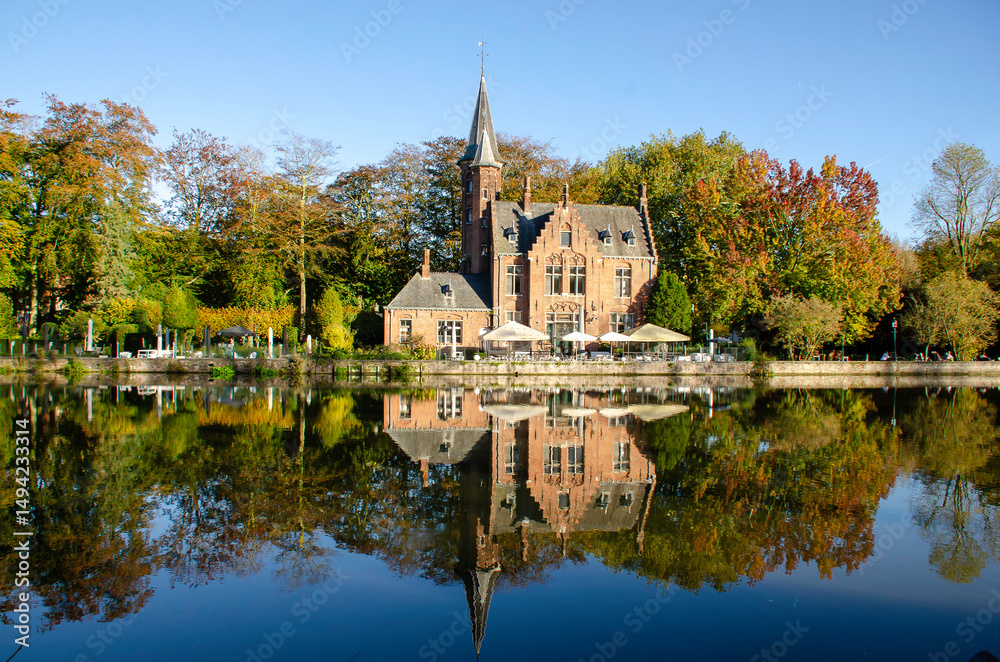Naklejka premium The Lake of Love in Bruges is an enchanting setting, perfect for romantics. With its graceful swans and serene landscape, the lake inspires passion and tranquility. Bruges, Belgium.