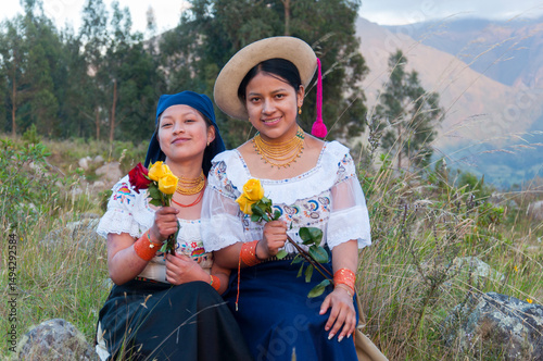 Indigenous quechua girls holding roses in the andes mountains