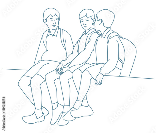  School friends talking while sitting together