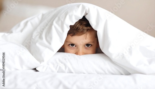 Boy Peeking Out From Under Blanket.