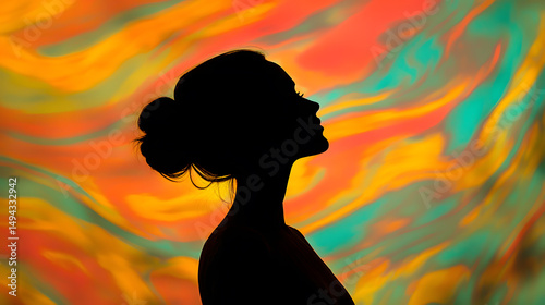 Silhouette Serenity: A woman's elegant silhouette, her gaze directed upwards, stands against a vibrant backdrop of swirling colors, evoking a sense of introspection, dreaminess and peacefulness.