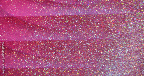 Flaring lens red. Blur glitter texture. Abstract colorful glow pink golden particles on bokeh light crimson background.