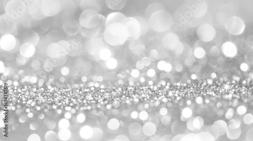 Blurred background of sparkling silver glitter with bokeh effect for festive designs and celebrations