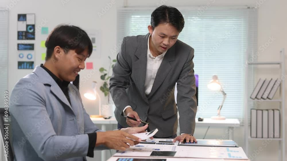 custom made wallpaper toronto digitalBusiness team working and discussing using calculator. Businessman engage in a discussion, analyzing business data and collaborating at an office desk.