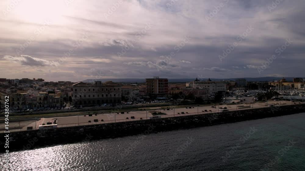 Journey across Syracuse, Italy, by drone, capturing sublime spectacle of its architectural marvels, golden shores. Sea sparkles with yachts, weaving through waters in picturesque dance of elegance Journey across Syracuse, Italy, by drone, capturing sublime spectacle of its architectural marvels, golden shores. Sea sparkles with yachts, weaving through waters in picturesque dance of elegance