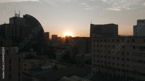 Golden hour aerial view of Ulaanbaatar city skyline in Mongolia with sunset over the mountains and modern high-rise buildings