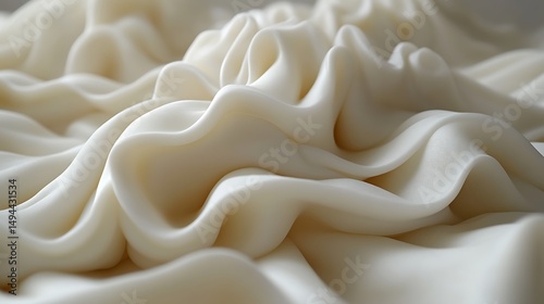 Creamy, off-white swirls and folds of a viscous substance.