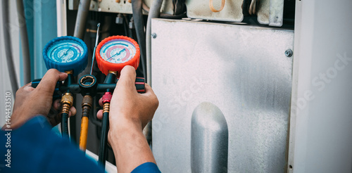 Technician is checking air conditioner refrigerant leak.