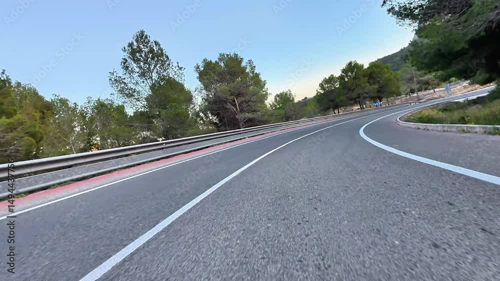 A stunning, beautiful winding road that is embraced by lush greenery and majestic mountains, ideal for scenic drives A stunning, beautiful winding road that is embraced by lush greenery and majestic mountains, ideal for scenic drives