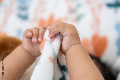 One year old asian girl enjoys cozy blanket moments at home warm and tender environment