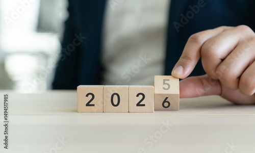 Transitioning from 2025 to 2026 with wooden blocks. Challenge target business for the upcoming year. Representing new year resolution, new beginnings, planning and success achievement.