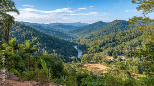 Lush tropical valley with dense forest, winding river, and distant mountain views